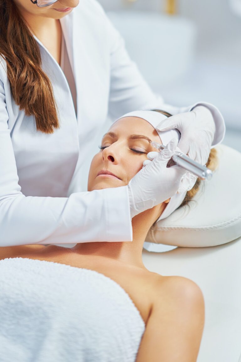 Woman having permanent eyebrows cosmetology treatment in salon