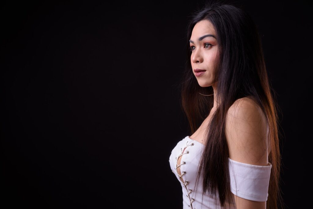 Profile view of young beautiful Asian transgender woman